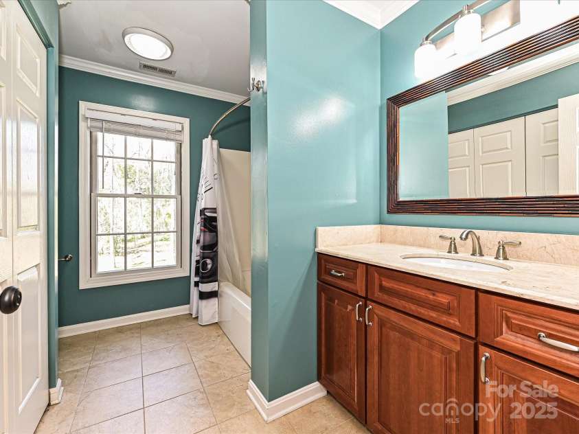 11 Tanglewood Road, Lake Wylie, SC 29710.  MLS# CAR4237959, YatesRealty ID 12829. Full hall bath with plenty of storage convenient laundry closet close to all bedrooms for convenience.  Washer and dryer are tucked away, offering easy access for laundry chores without taking up additional space elsew