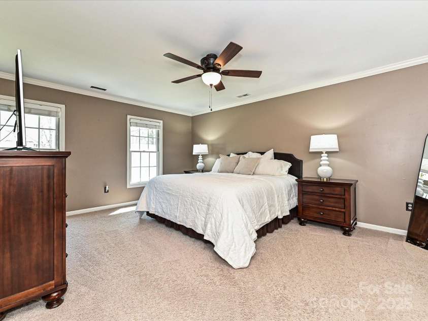 11 Tanglewood Road, Lake Wylie, SC 29710.  MLS# CAR4237959, YatesRealty ID 12829. Retreat to the expansive primary bedroom, a true sanctuary designed for comfort and relaxation.