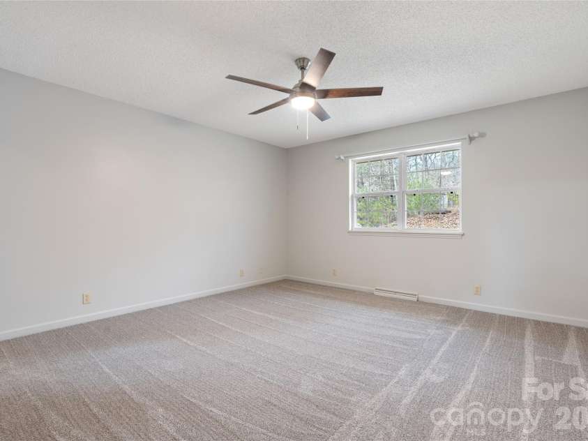 177 Country Road, Brevard, NC 28712.  MLS# CAR4331817, YatesRealty ID 12832. Main level Primary bedroom