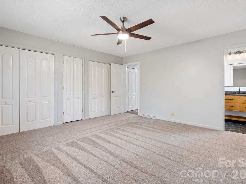 177 Country Road, Brevard, NC 28712.  MLS# CAR4331817, YatesRealty ID 12832. Primary bedroom into primary bathroom
