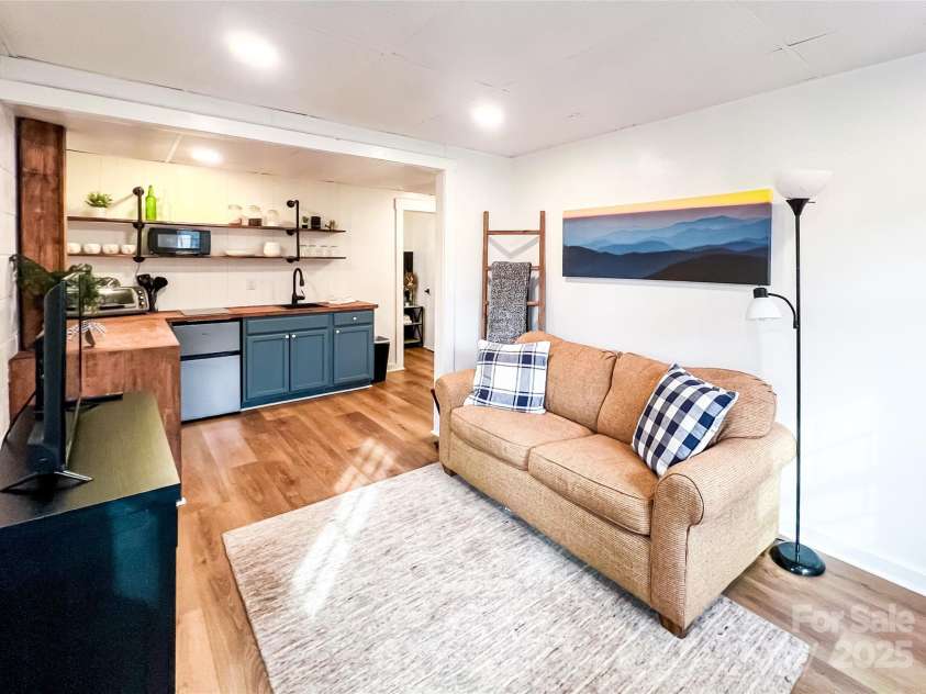 805 Reems Creek Road, Weaverville, NC 28787.  MLS# CAR4206802, YatesRealty ID 12835. Basement living room.