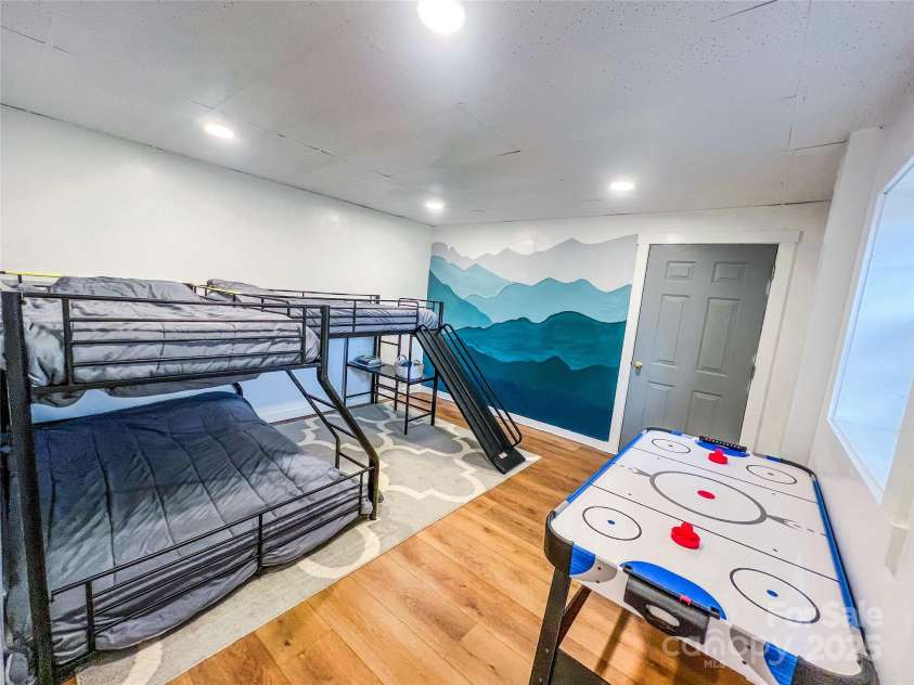 805 Reems Creek Road, Weaverville, NC 28787.  MLS# CAR4206802, YatesRealty ID 12835. This fun room can be used a lot of different ways but currently has three beds and an air hockey table! So much room!