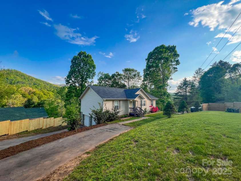 805 Reems Creek Road, Weaverville, NC 28787.  MLS# CAR4206802, YatesRealty ID 12835. This house has TONS of parking. Lower driveway can easily park two cars and has extra large garage, also places to park multiple cars on upper driveway PLUS there’s a parking spot across from these for the basement 