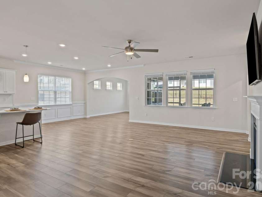4840 Maiden Creek Way, Maiden, NC 28650.  MLS# CAR4367470, YatesRealty ID 12836. Expansive great room and dining area with recessed LED lighting, an arched entry dining/keeping room area, fireplace and wall-mounted TV.  Upgraded ceiling fans throughout.  Marble hearth.
