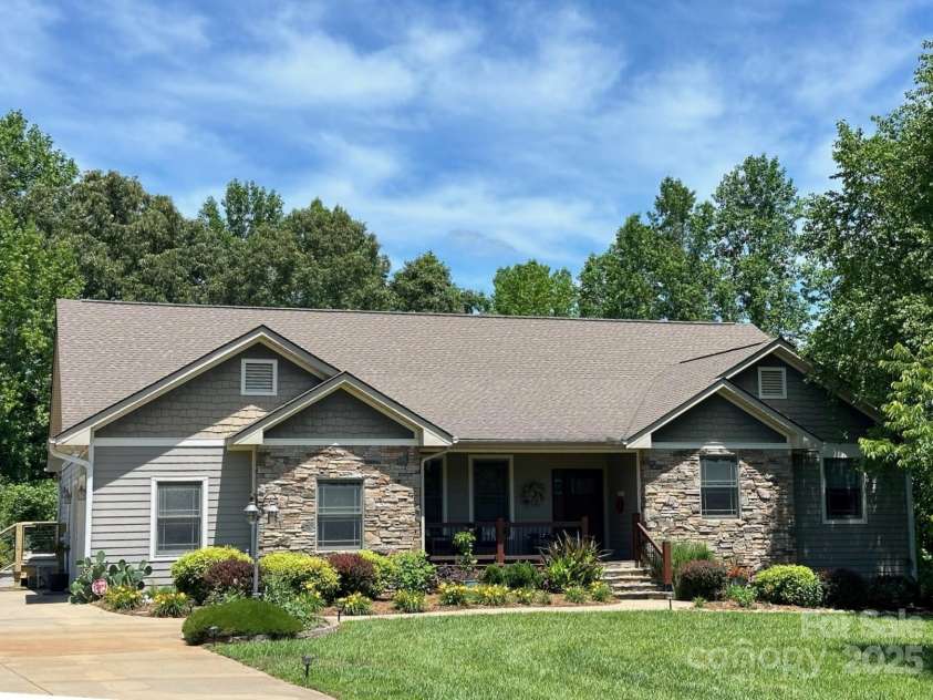 169 Stoneybrook Way, Tryon, NC 28782.  MLS# CAR4217213, YatesRealty ID 1286. Three seasons a year lush color framing the house.