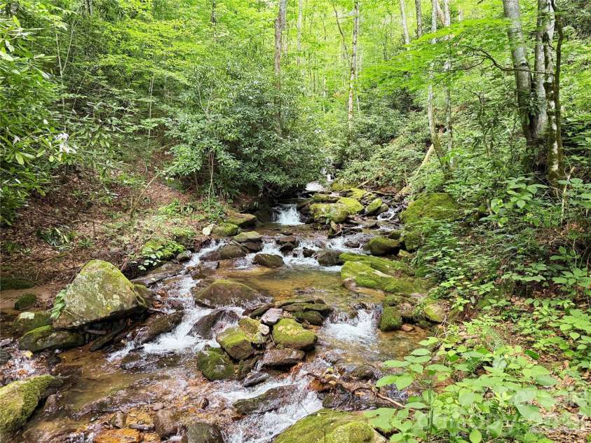 226 Wildcat Mountain Trail, Sylva, NC 28779.  MLS# CAR4284312, YatesRealty ID 12873. Bold creek with cascading waterfalls heard from primary bedroom