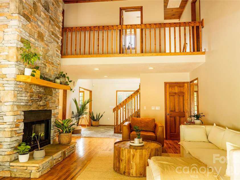 226 Wildcat Mountain Trail, Sylva, NC 28779.  MLS# CAR4284312, YatesRealty ID 12873. Great room with stone fireplace
