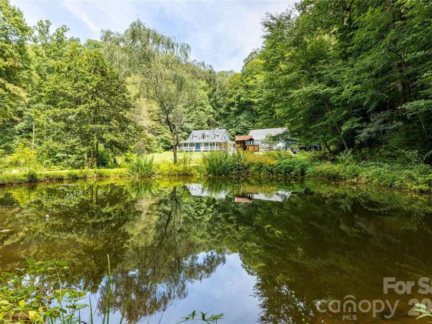 226 Wildcat Mountain Trail, Sylva, NC 28779.  MLS# CAR4284312, YatesRealty ID 12873. View of home from the spring fed pond