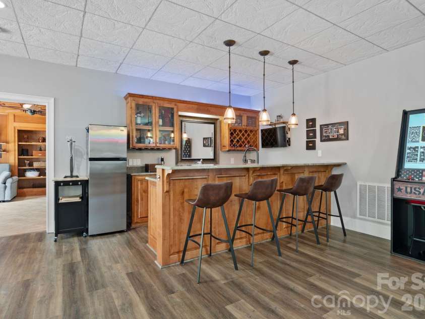 183 April Road, Troutman, NC 28166.  MLS# CAR4365014, YatesRealty ID 12908. Dedicated bar with seating, beverage fridge, sink and small refridgerator