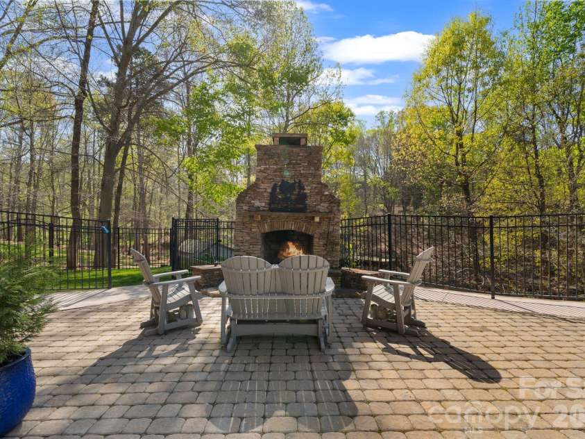 183 April Road, Troutman, NC 28166.  MLS# CAR4365014, YatesRealty ID 12908. Wood burning fireplace overlooking the lake 