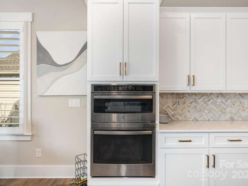 21016 Molly Harper Drive, Cornelius, NC 28031.  MLS# CAR4320388, YatesRealty ID 12915. Stacked ovens as end cap to the kitchen space. 