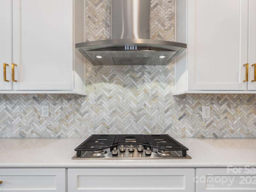 21016 Molly Harper Drive, Cornelius, NC 28031.  MLS# CAR4320388, YatesRealty ID 12915. Stunning herringbone tile 