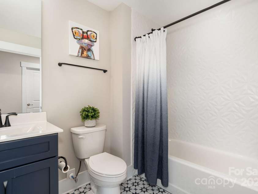 21016 Molly Harper Drive, Cornelius, NC 28031.  MLS# CAR4320388, YatesRealty ID 12915. Upstairs full bath features a tub with custom tile