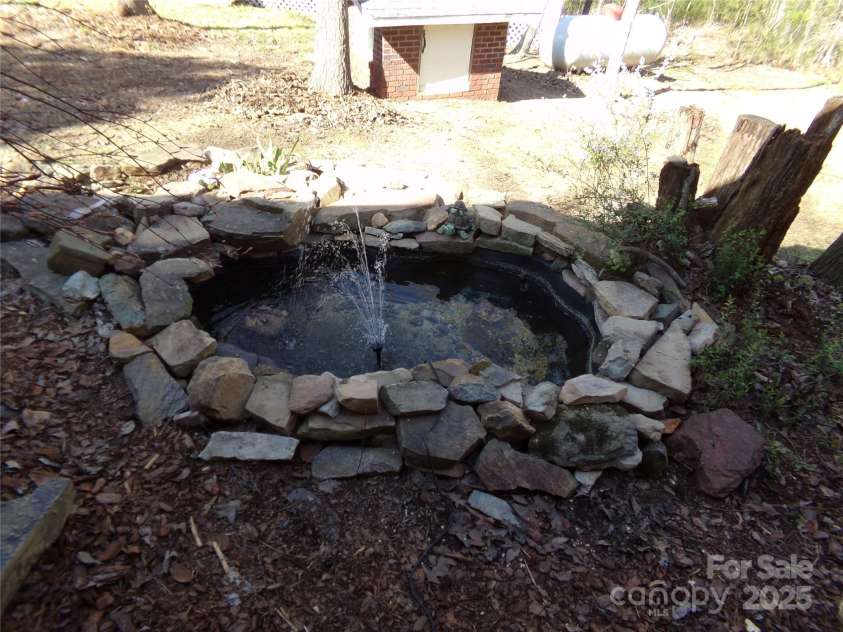 7218 Alexander Farm Road, Monroe, NC 28110.  MLS# CAR4238823, YatesRealty ID 12919. Small pond with gold fish