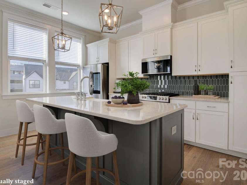 5939 Ardrey Kell Road, Charlotte, NC 28277.  MLS# CAR4352404, YatesRealty ID 12929. Virtually Staged open kitchen with spacious island, gas range, & plenty of cabinet storage