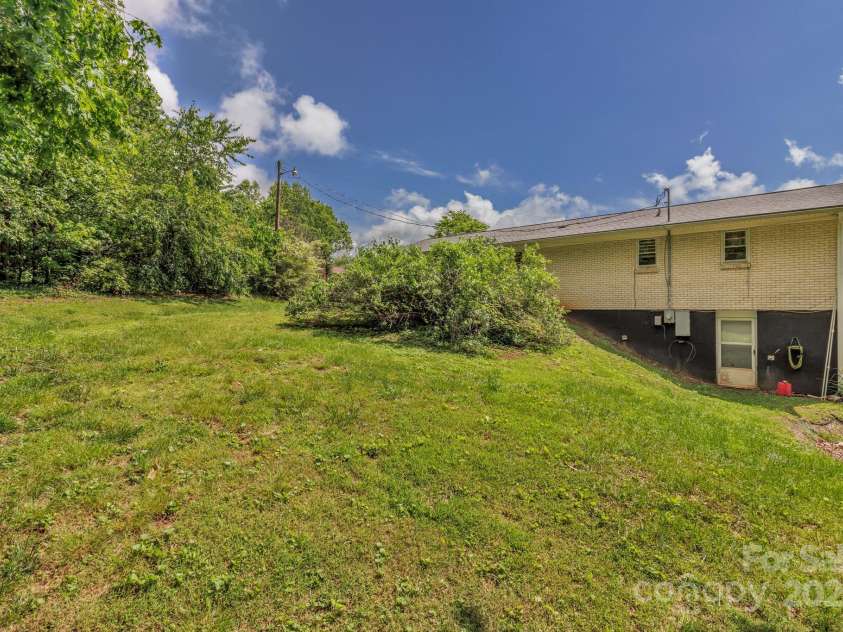 676 Arrowhead Trail, Marion, NC 28752.  MLS# CAR4252905, YatesRealty ID 12932. Back view of the house showing the basement and exterior access. Basement also has direct access from inside.