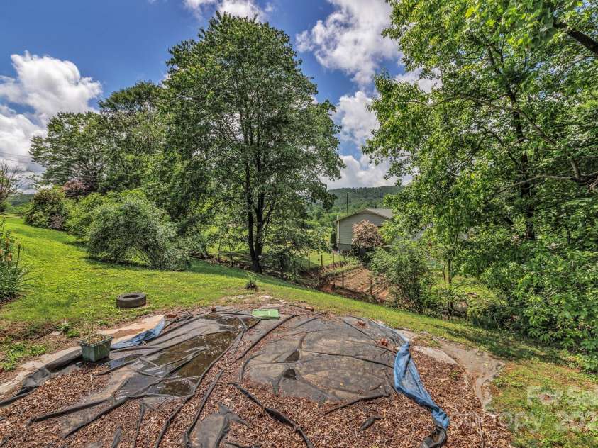 676 Arrowhead Trail, Marion, NC 28752.  MLS# CAR4252905, YatesRealty ID 12932. Flat area next to the house used to have an above ground pool.