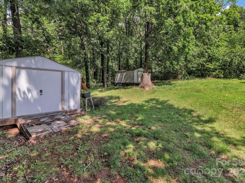 676 Arrowhead Trail, Marion, NC 28752.  MLS# CAR4252905, YatesRealty ID 12932. Large private back yard with storage sheds.