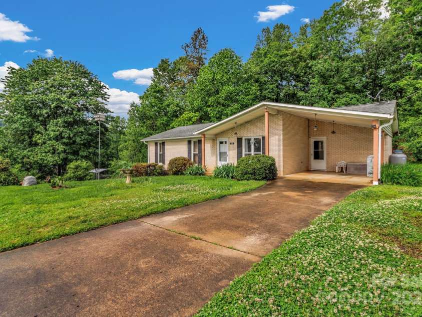 676 Arrowhead Trail, Marion, NC 28752.  MLS# CAR4252905, YatesRealty ID 12932. One level Brick home with unfinished half basement and level driveway and carport.