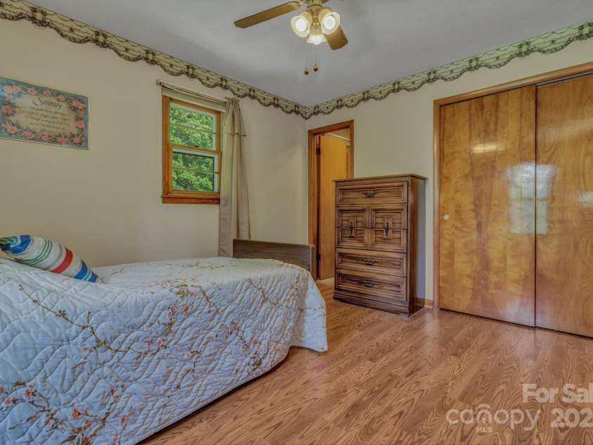 676 Arrowhead Trail, Marion, NC 28752.  MLS# CAR4252905, YatesRealty ID 12932. This bedroom has a half bath attached.