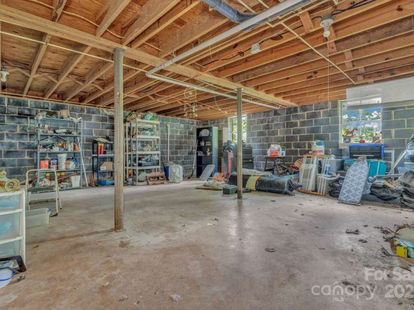 676 Arrowhead Trail, Marion, NC 28752.  MLS# CAR4252905, YatesRealty ID 12932. Unfinished basement with inside and outside access including utilities and washer dryer hookup.