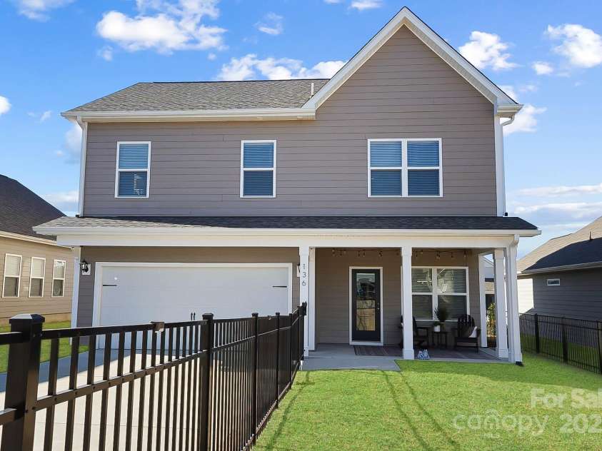 136 Kingston Drive, Locust, NC 28097.  MLS# CAR4227262, YatesRealty ID 12944. Covered rear patio and fenced in back yard, virtually edited grass