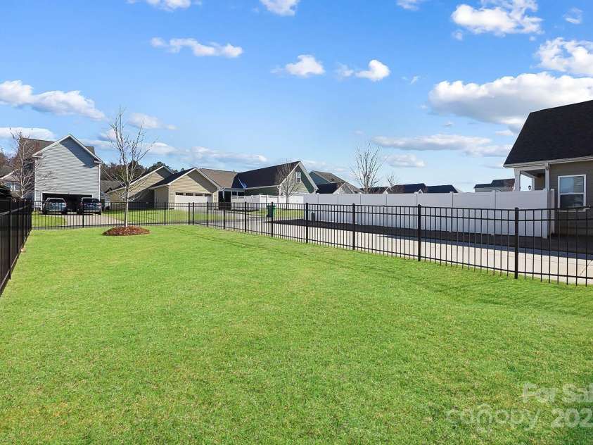 136 Kingston Drive, Locust, NC 28097.  MLS# CAR4227262, YatesRealty ID 12944. Large fenced in back yard, virtually edited grass