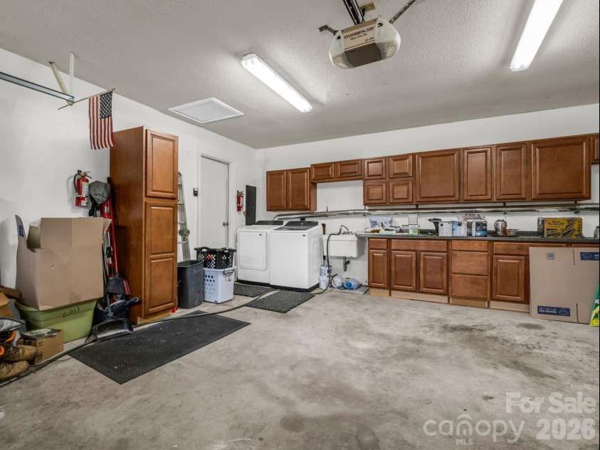 54 Broadway Avenue, Tryon, NC 28782.  MLS# CAR4357107, YatesRealty ID 12954. Laundry Area w/ Sink and Built-in Storage in Garage
