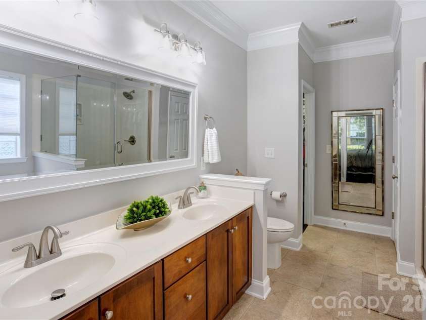 2663 Danbury Circle, Concord, NC 28027.  MLS# CAR4394399, YatesRealty ID 12988. Large primary bath with double vanities, updated semi-frameless shower and soaking tub.