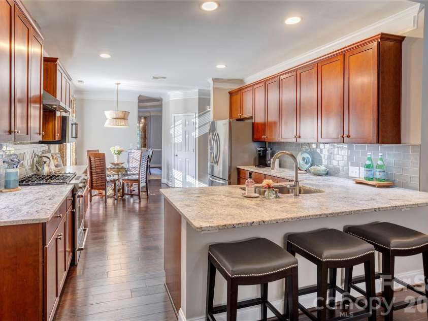 2663 Danbury Circle, Concord, NC 28027.  MLS# CAR4394399, YatesRealty ID 12988. Look at this updated kitchen!  Honed granite counter tops, tile backsplash, updated lighting, gas range/oven and hood.