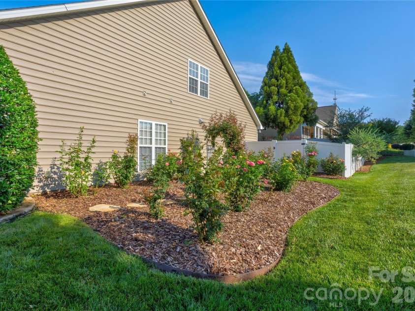 2663 Danbury Circle, Concord, NC 28027.  MLS# CAR4394399, YatesRealty ID 12988. Side yard rose garden.