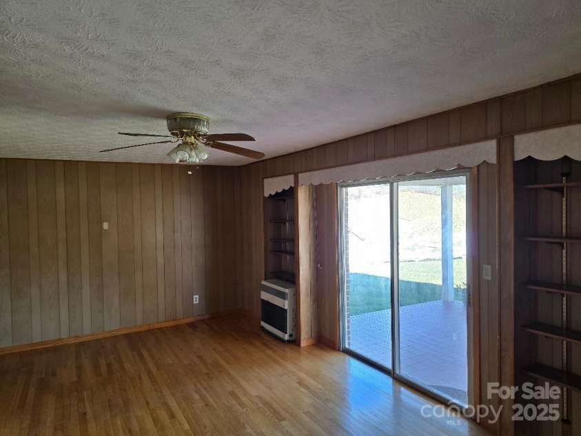 1375 US Highway 19E Highway, Burnsville, NC 28714.  MLS# CAR4329254, YatesRealty ID 1299. Den with ceiling fan, hardwood floors