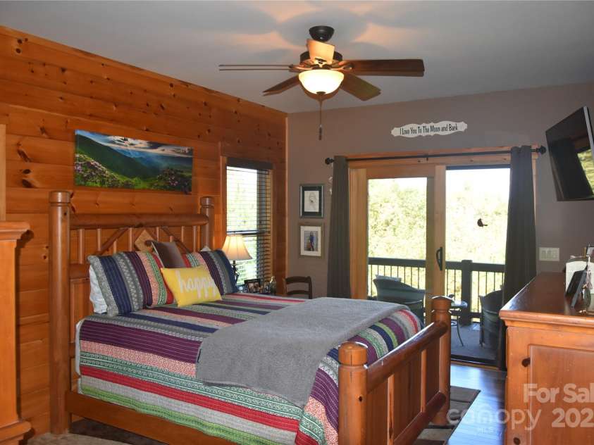 80 Grandview Loop, Nebo, NC 28761.  MLS# CAR4317495, YatesRealty ID 1300. Master bedroom with adjoining screened in sitting area.