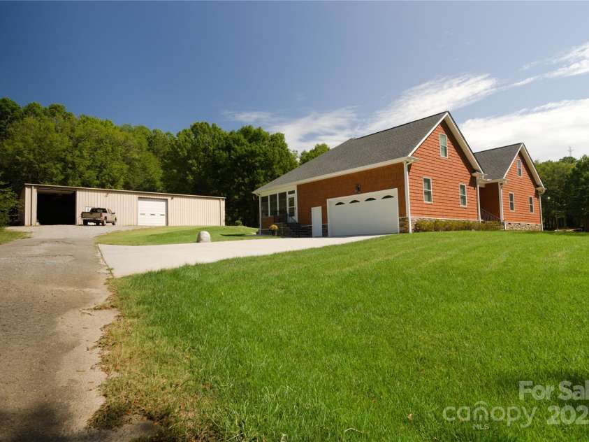 15027 Beatties Ford Road, Huntersville, NC 28078.  MLS# CAR4308450, YatesRealty ID 1303. Driveway, house and building