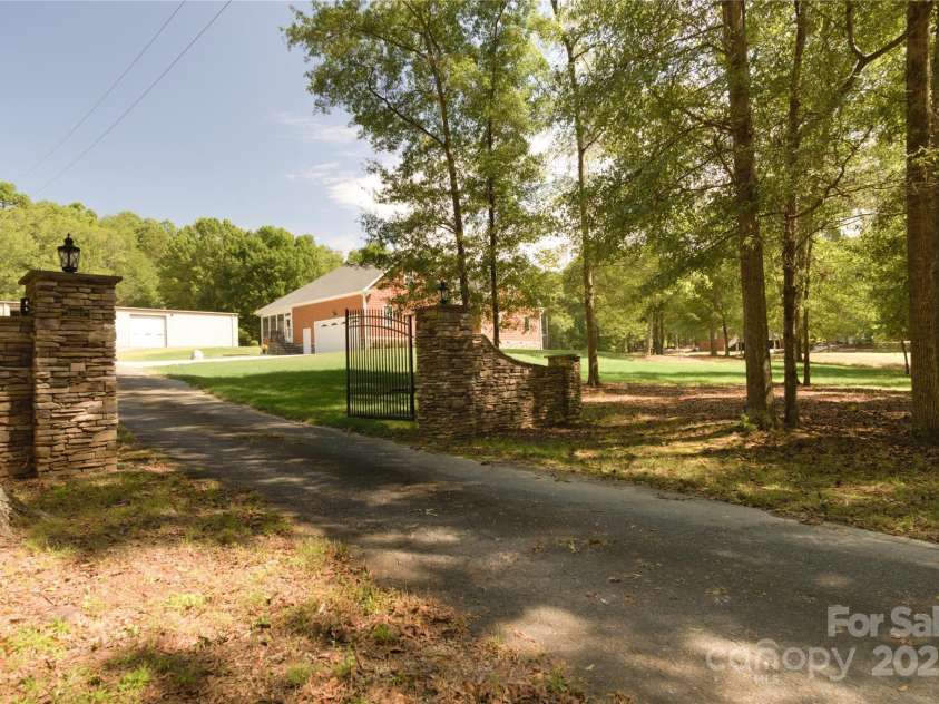 15027 Beatties Ford Road, Huntersville, NC 28078.  MLS# CAR4308450, YatesRealty ID 1303. Gated entrance