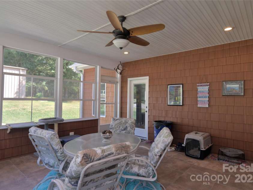 15027 Beatties Ford Road, Huntersville, NC 28078.  MLS# CAR4308450, YatesRealty ID 1303. Screened in porch area