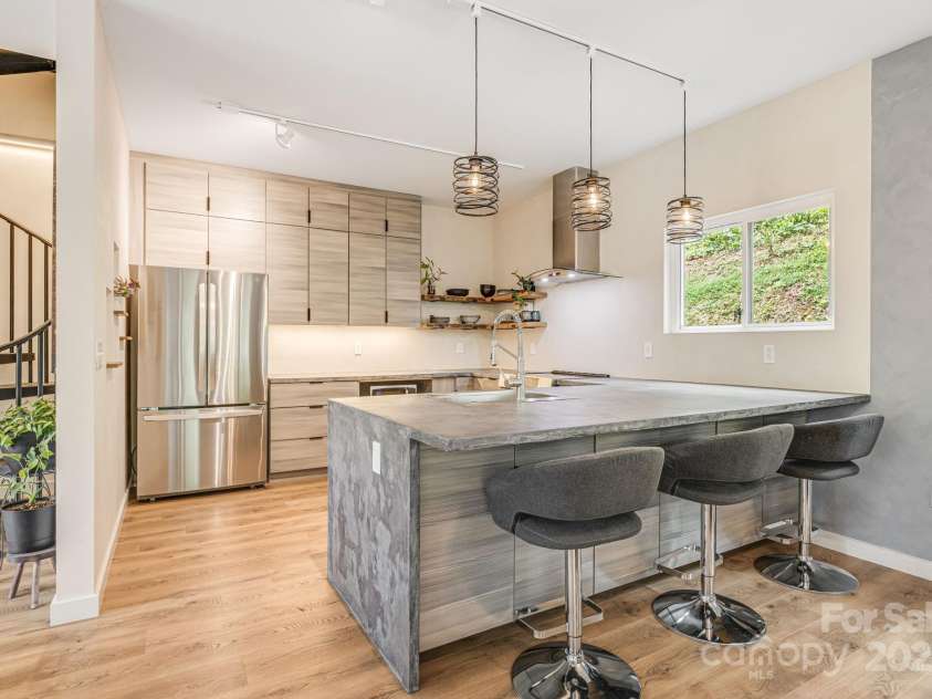 47 Webb Cove Road, Asheville, NC 28804.  MLS# CAR4234951, YatesRealty ID 13033. Closer view of the breakfast bar and modern kitchen
