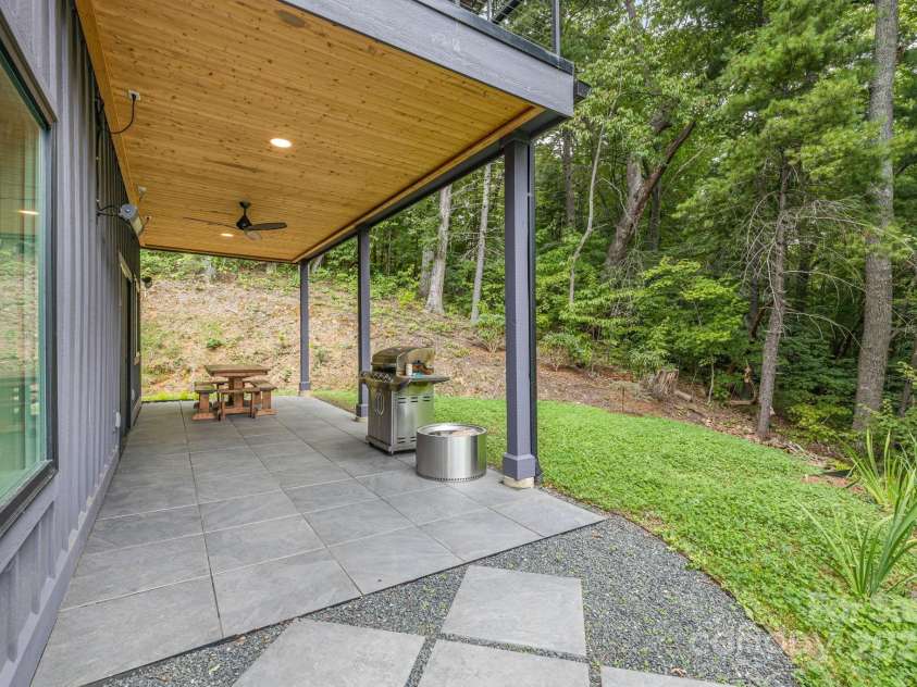 47 Webb Cove Road, Asheville, NC 28804.  MLS# CAR4234951, YatesRealty ID 13033. Enjoy outdoor dining or your grill under the private covered side patio surrounded by the woods