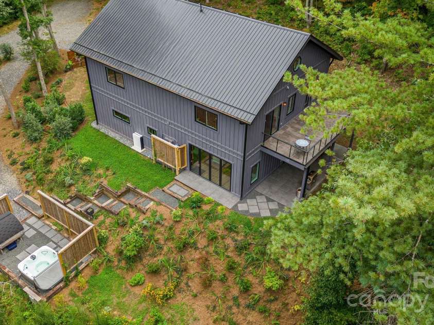 47 Webb Cove Road, Asheville, NC 28804.  MLS# CAR4234951, YatesRealty ID 13033. Great aerial view showing the lower driveway with easy access to main living area, while walking by the spa area with hot tub and sauna