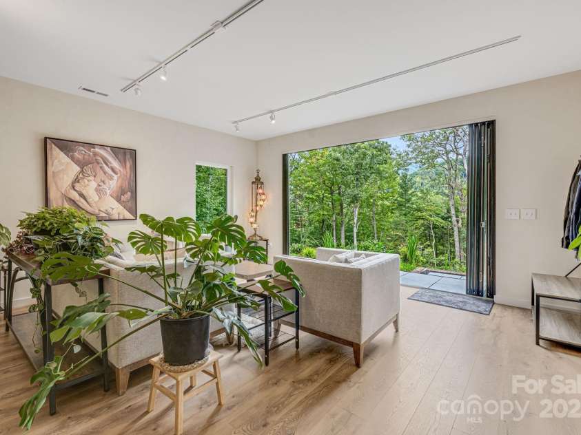 47 Webb Cove Road, Asheville, NC 28804.  MLS# CAR4234951, YatesRealty ID 13033. Great view out the open doors, giving a luxury treehouse sanctuary feel