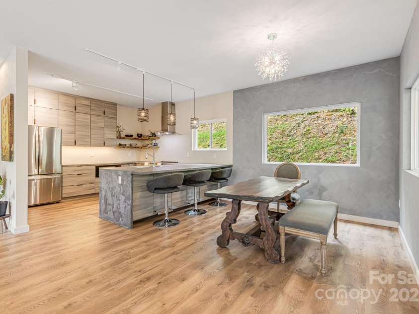 47 Webb Cove Road, Asheville, NC 28804.  MLS# CAR4234951, YatesRealty ID 13033. Open floor plan overlooks modern kitchen with breakfast bar and dining area