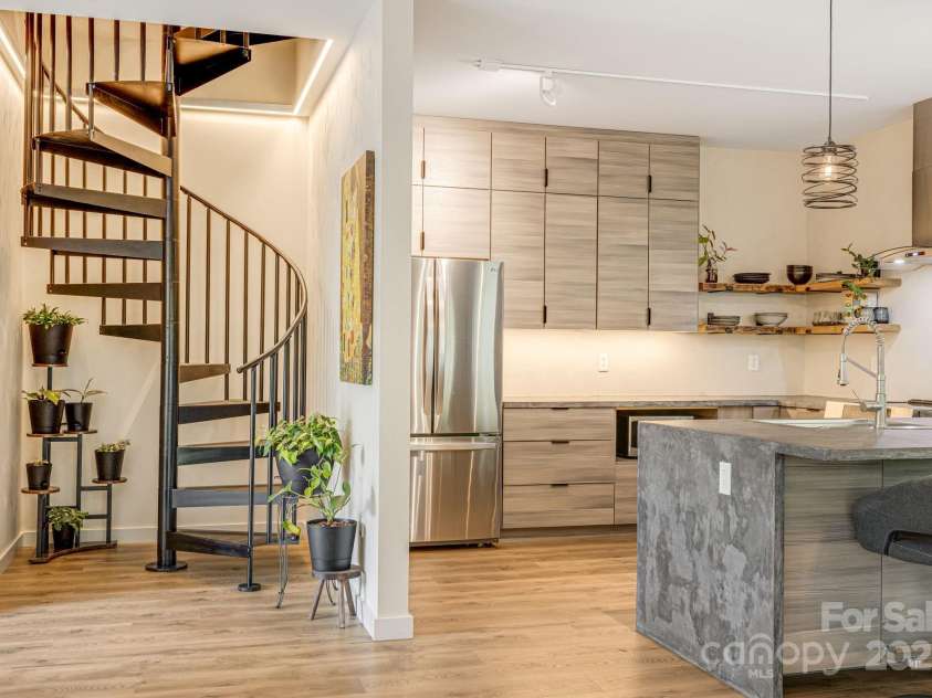 47 Webb Cove Road, Asheville, NC 28804.  MLS# CAR4234951, YatesRealty ID 13033. Spiral staircase, next to luxury kitchen leads to upper level bedrooms