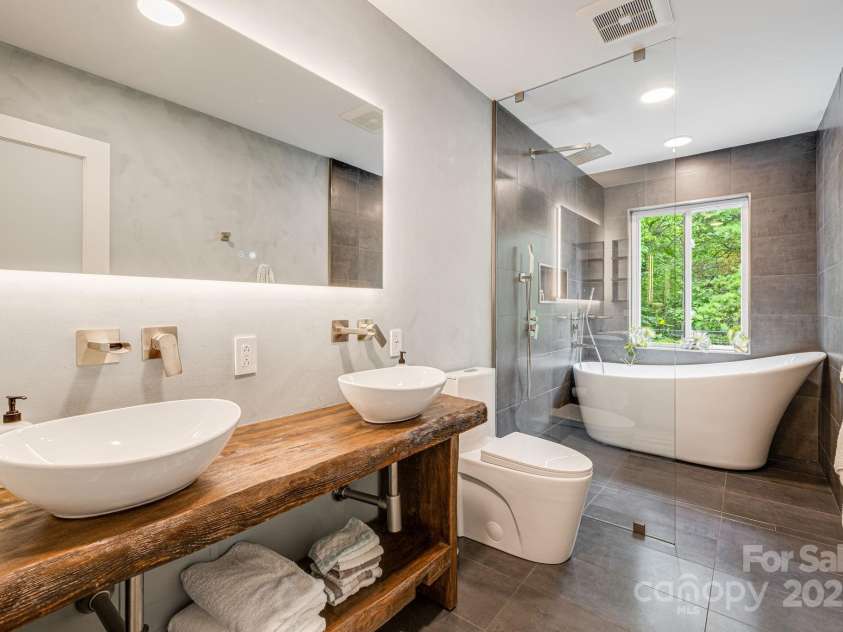 47 Webb Cove Road, Asheville, NC 28804.  MLS# CAR4234951, YatesRealty ID 13033. Upstairs bathroom boasts double vanity sinks, lux toilet, and amazing soaking tub