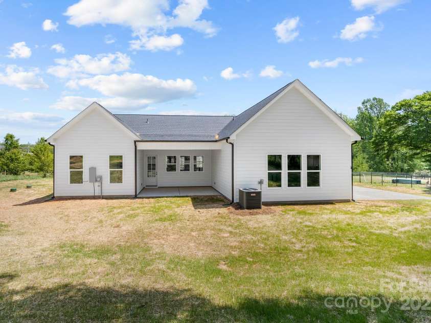 1037 Dameron Road, Bessemer City, NC 28016.  MLS# CAR4226755, YatesRealty ID 13043. Back Elevation Showing the Covered Back Porch the ample Driveway and Spacious Back Yard