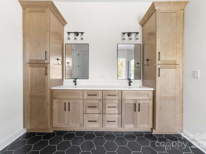 1037 Dameron Road, Bessemer City, NC 28016.  MLS# CAR4226755, YatesRealty ID 13043. Elegant His and Her's SinKs and Cabinets, the Perfect Complement to the Rest of this Truly Sophisticated Primary Bathroom.