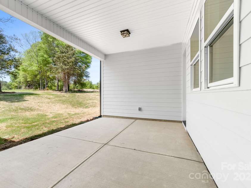 1037 Dameron Road, Bessemer City, NC 28016.  MLS# CAR4226755, YatesRealty ID 13043. Spacious Covered Back Porch with view of the expansive back yard