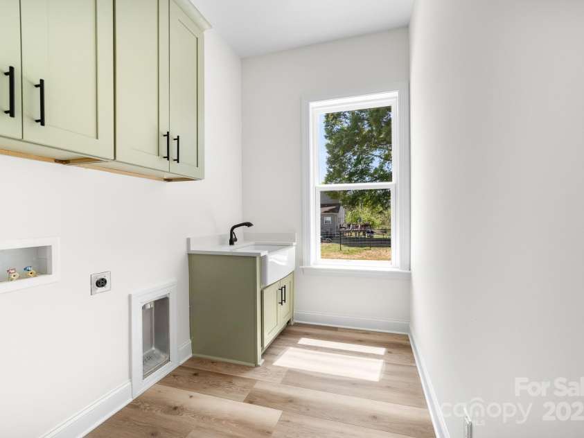 1037 Dameron Road, Bessemer City, NC 28016.  MLS# CAR4226755, YatesRealty ID 13043. View of Noteworthy Laundry Room with Farmhouse Sink and Cabinets Matching the Butler's Pantry!