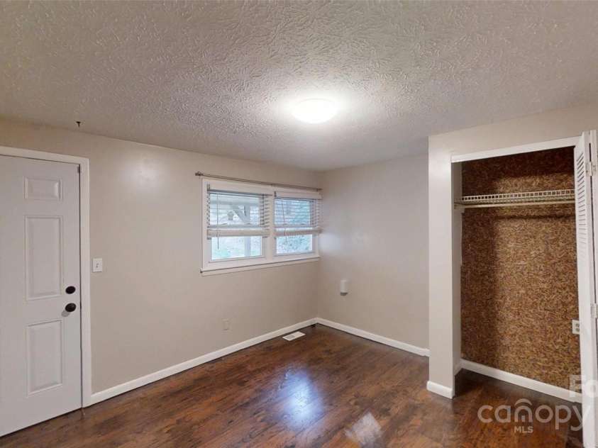 59 Upper Saw Branch Road, Candler, NC 28715.  MLS# CAR4226917, YatesRealty ID 13059. Bedroom two with exit door to back porch