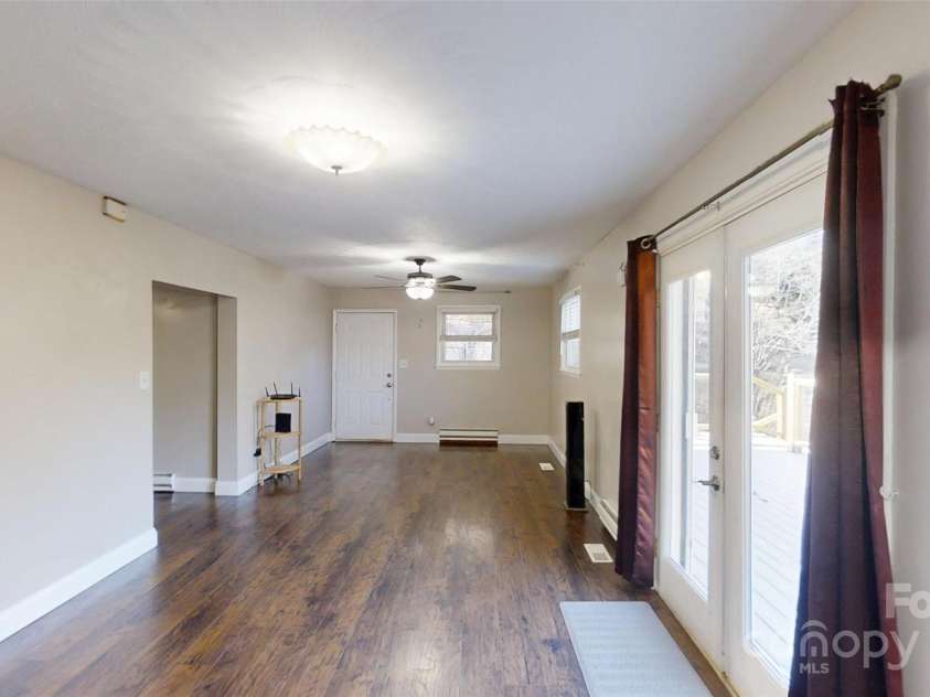 59 Upper Saw Branch Road, Candler, NC 28715.  MLS# CAR4226917, YatesRealty ID 13059. Living room view from kitchen