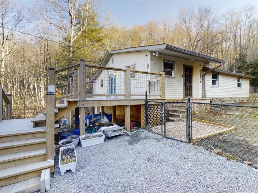 59 Upper Saw Branch Road, Candler, NC 28715.  MLS# CAR4226917, YatesRealty ID 13059. Side view of home and yard